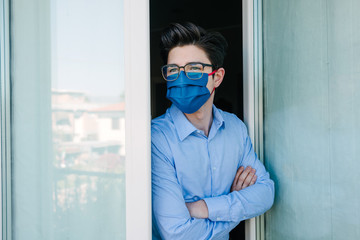 Young businessman with mask forced to stay in quarantine at home