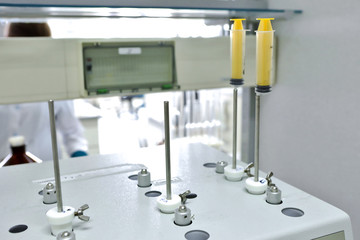 A female chemist conducts solubility tests of tablets and other dosage forms. Erveka - Scientific research pharmaceutical laboratory. A man conducts scientific work in a factory. Laboratory research.