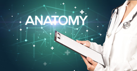 Doctor fills out medical record with ANATOMY inscription, medical concept