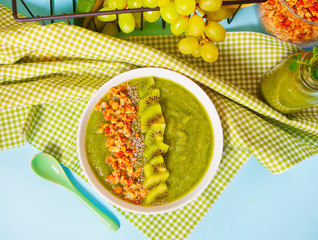 Fresh blended green smoothie bowl with muesli and chia seeds. Health and detox concept. Top view.