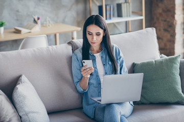 Portrait of her she nice attractive lovely focused brunet girl sitting on divan using digital device working remote education in modern loft industrial flat house apartment indoors