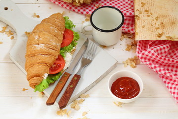Croissant with tomatoes, cheese and ham not a white background