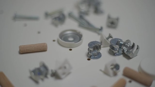 Close up men's hand puts details for furniture. Minifix Furniture