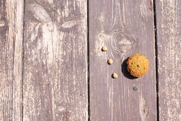 roasted chickpeas falafel one ball piece. and three small hummus. Top view. on the wood background