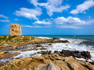Fototapeta na wymiar The symbol of the city of Bari Sardo, a tower built on a rocky outcrop on the sea with crystalline water