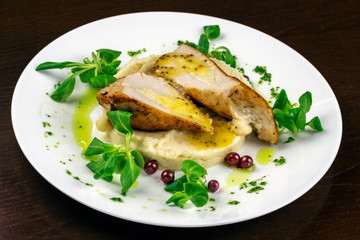 mashed potatoes with chicken breast and herbs in a sauce with berries