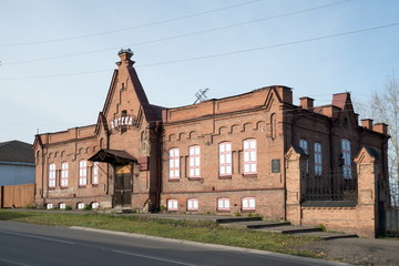 Fototapeta na wymiar The building of the city hospital (1898) on an autumn sunny day in the city of Yeniseysk. Krasnoyarsk region. Russia