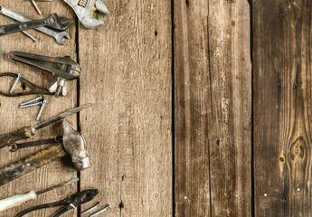 A set of metal tools in the workshop on an old rustic wooden background.concept.Father's day or labor day holiday.A greeting card or banner for your store or website.Copyspace.Mock up.Flat lay