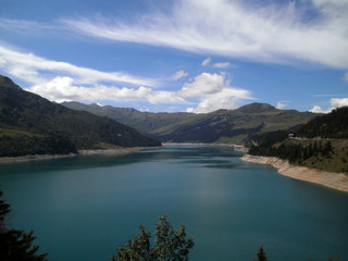 Obraz premium View of the lake Roselend, which is mainly a reservoir in the French alpine mountains.