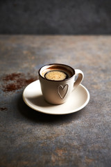 Cup of black coffee on rustic background. Copy space