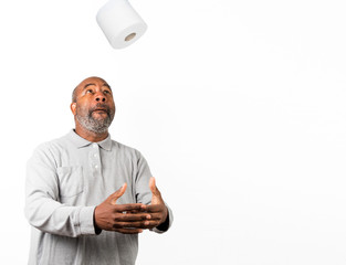 African American man with toilet paper during Corona Virus crisis. Dark Humor with copy space. Concept of Lockdown, Flatten the Curve, Social Distancing, State of Emergency