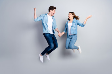 Full size photo of cheerful two students jump hold hands celebrate weekend lottery discount win...