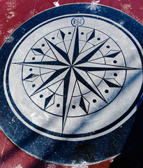 old compass on a wall red and blue