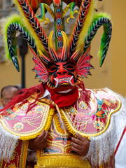 Traditional very colorful mask of a demon at carnival celebrations in Lima, Peru