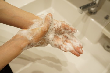 Fototapeta premium COVID-19 coronavirus prevention is one of the most important ways to wash hands with water and soap. The point is to make foam using a hand soap and wash slowly and carefully over 20 seconds or more.