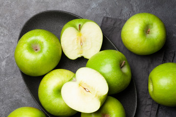 Ripe green apple fruits on dark stone table