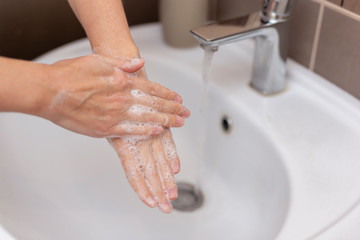 Woman disinfecting and washing hands