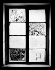 Old wooden window missing some pieces of glass. Old/retro style wooden window in black and white.