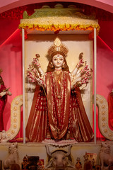 Idol of Goddess Devi Durga at a decorated puja pandal in Kolkata, West Bengal, India. Durga Puja is...