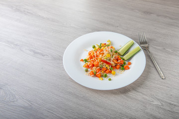 Hawaiian vegetable mix on light wooden table with copy space