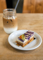 Purple taro cream cake with biscuit and ice coffee