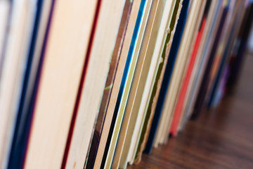 stack of old book on wooden table, education concept background, many books piles with copy space for text.