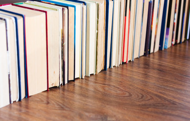 stack of old book on wooden table, education concept background, many books piles with copy space for text.