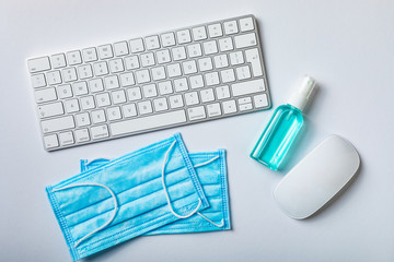 Coronavirus. Working from home. Pandemic Covid-19 quarantine. Protective face mask, sanitizer gel,...