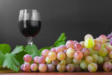 bunch of grape with vine leaves