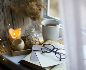 autumn tea with candles book and old letters