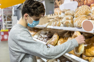 Young man wearing face mask, going for shopping at epidemic coronavirus time.