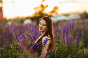 Flowers and the woman palm in the field. Lit evening sun