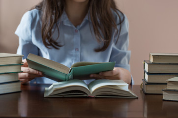 teenage girl reading lots of books