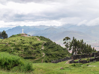 Statue of christ and landscape at Cusco, Peru