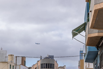 Aircraft captured during a descent to an airport while landing between two buildings from a...