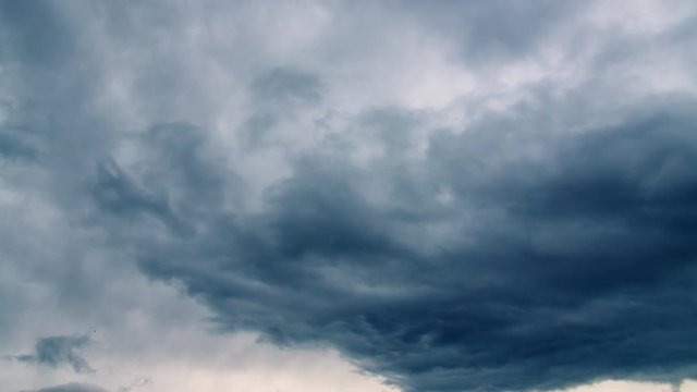 Dark blue thunderstorm clouds rolling like waves in the sky timelapse
