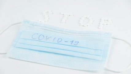 Stop COVID-19 concept: pills and white mask. Coronavirus