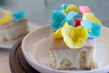Lemon and poppy seeds loaf cake decorated with pastel fondant flowers