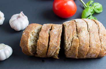 Ciabatta bread on black background. Ciabatta is an Italian white bread made from wheat flour, water, olive oil, salt, and yeast,