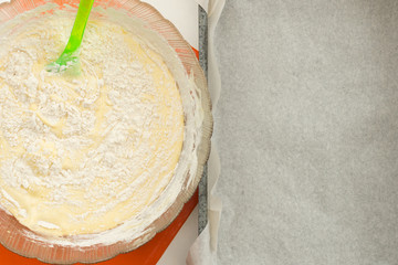 recipe step by step dough for biscuit next to a pan with parchment close-up