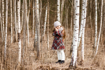 little girl in the birch forest in spring