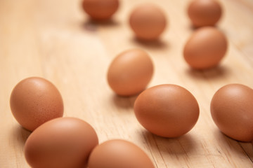 Close up of raw chicken eggs on a wooden background