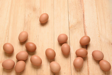 Raw chicken eggs on a wooden background