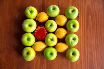 Coronavirus hiding in usual things - check cleanse and freshness of your fruits and food. One of the bunch. Apples, oranges, lemons on the kitchen's table. Pandemic, epidemic concept, disinfecting.