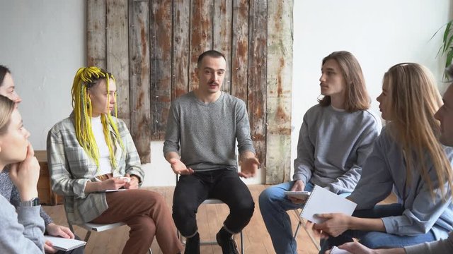 Young people at rehab group meeting, anonymous alcoholics gathered to share problems and get advice, psychology therapy.