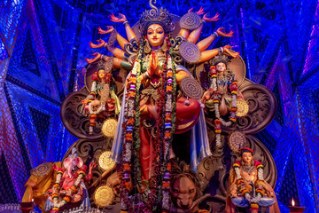 Idol of Goddess Devi Durga at a decorated puja pandal in Kolkata, West Bengal, India. Durga Puja is...