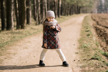 little girl on a forest path in spring