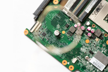 Laptop motherboard closeup. Printed circuit Board with SMD components. view through a magnifying...