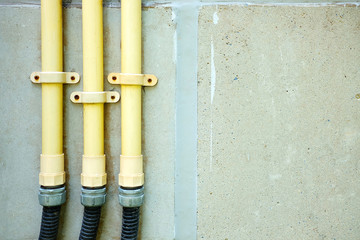 Electric Wire PVC Hose on Concrete Wall Background.