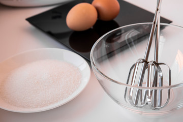White sugar, two eggs, whisk mixer for making meringue